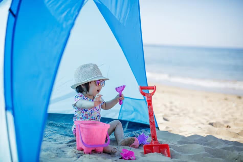 baby girl playing at summer beach