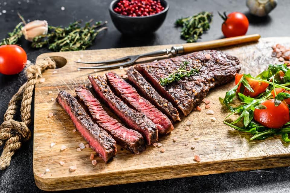 A photo taken from above of a London Broil, a sliced flank steak.