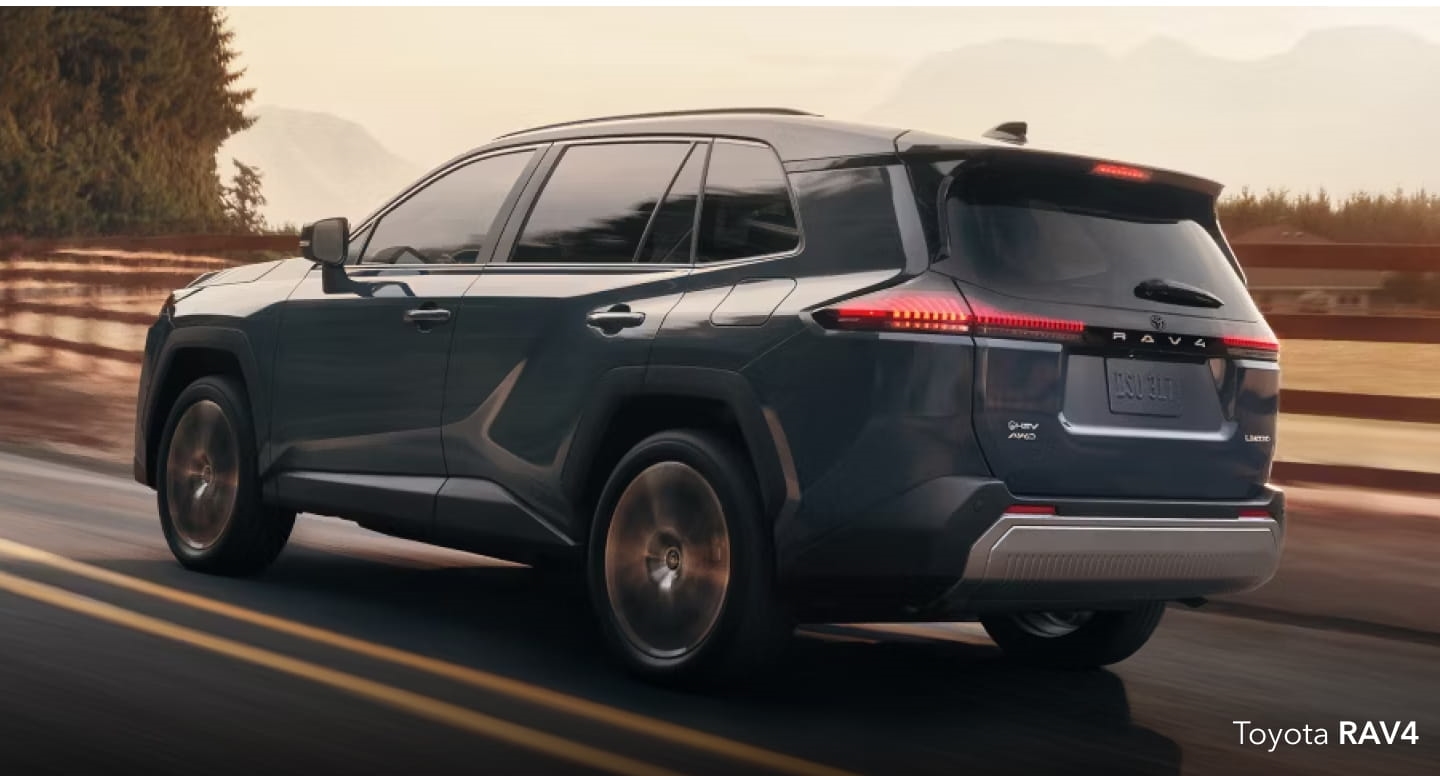 Gray Toyota RAV4 driving on a scenic mountain road.