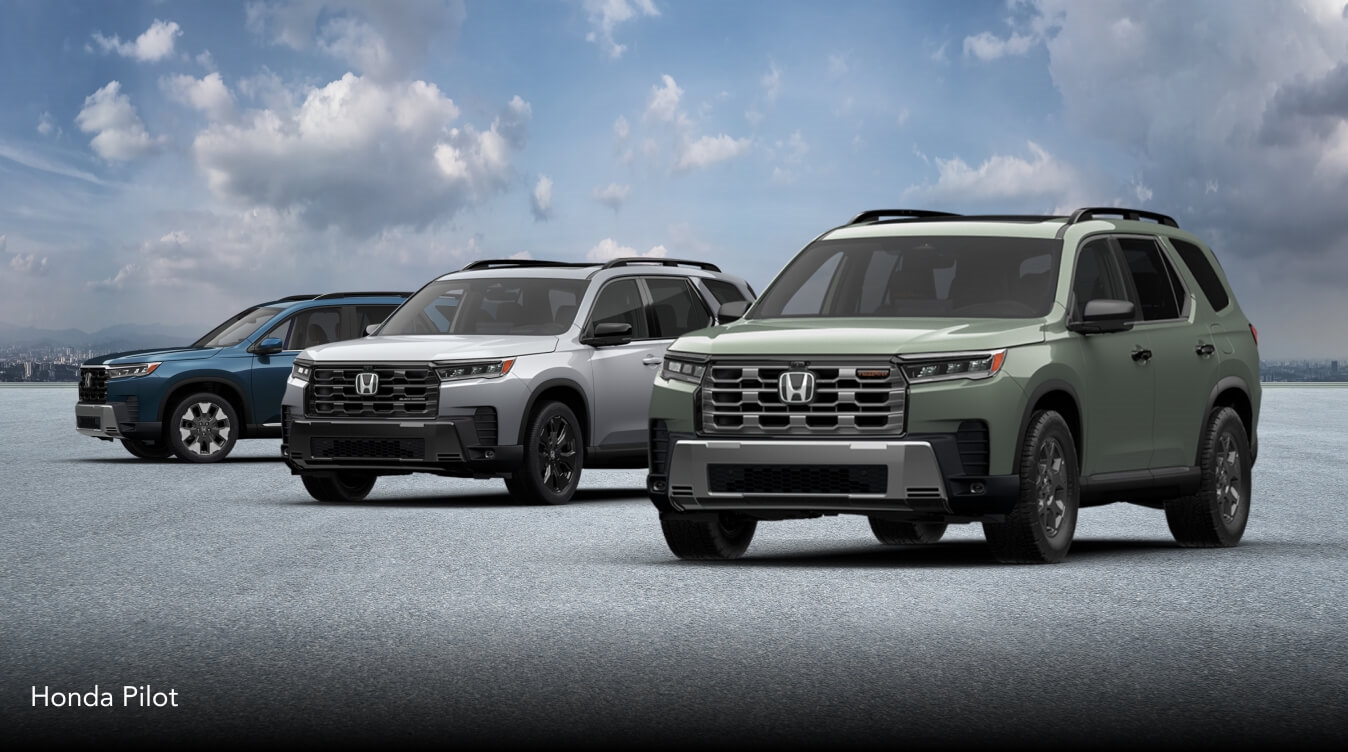 Three Honda Pilots in Elite, Black Edition and Trailsport trims, parked side-by-side in front of a cloudy sky background.