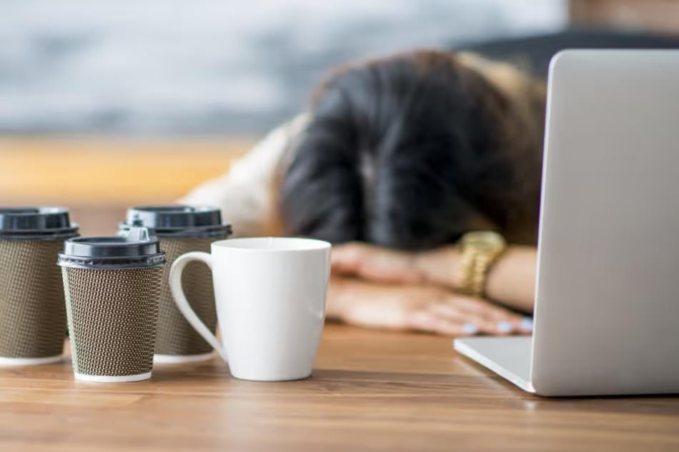 Woman struggling to stay awake at work