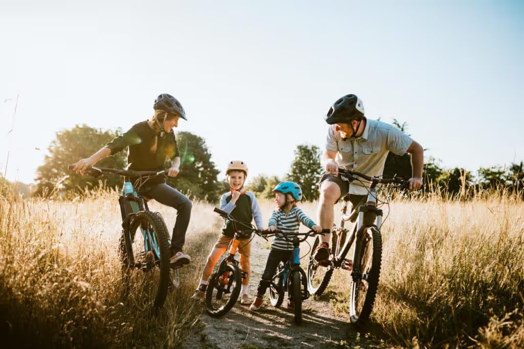 Family riding bikes on a trail
