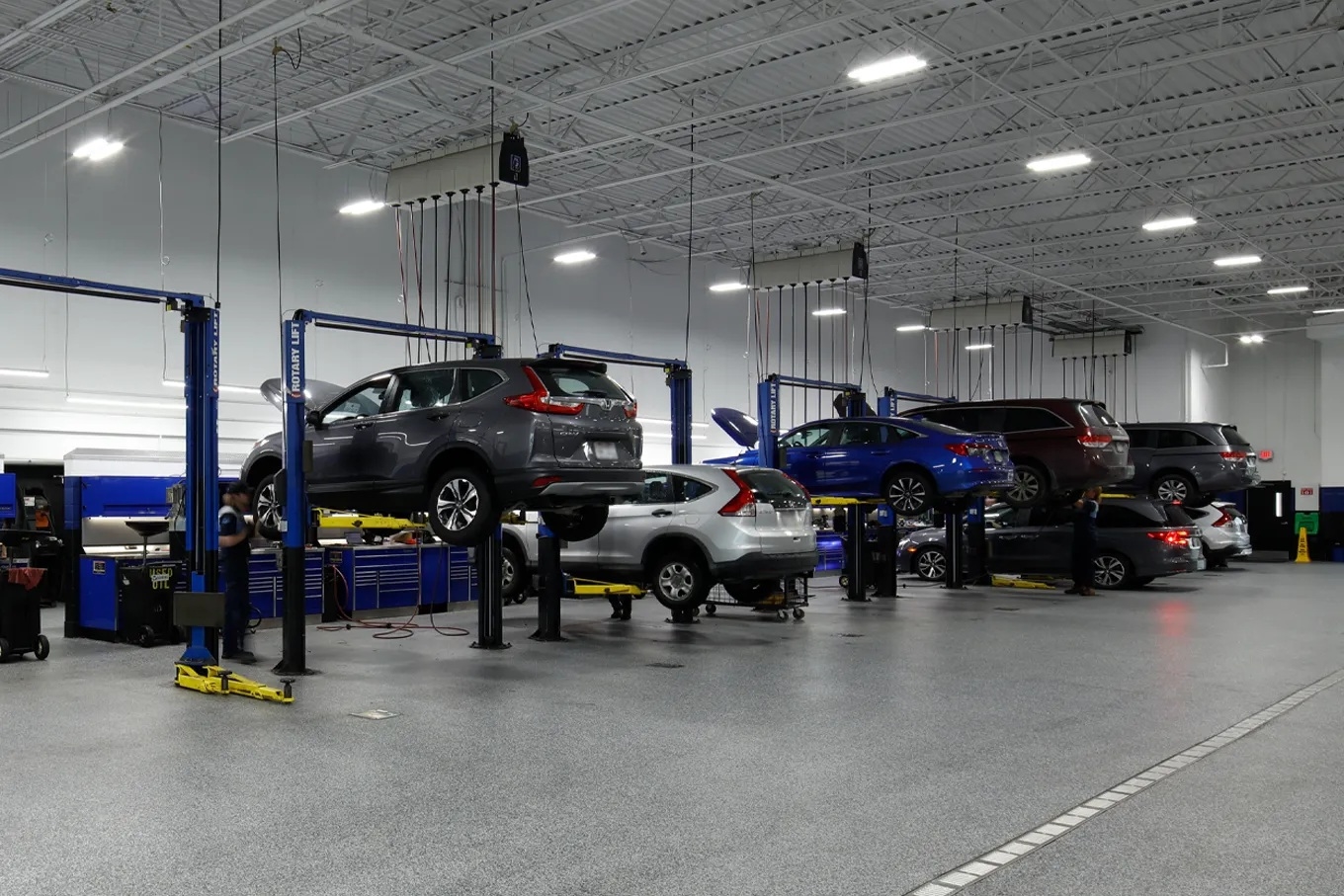 A Honda Pilot inside a Honda service bay