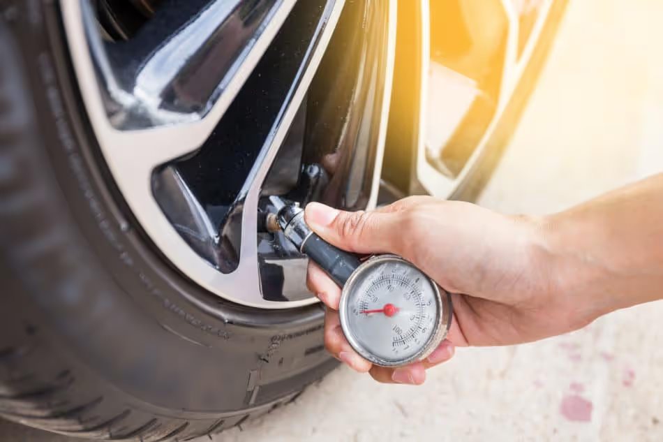 close up of hand checking tire pressure