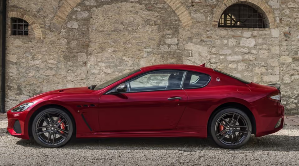 Red GranTurismo Against Stone Wall