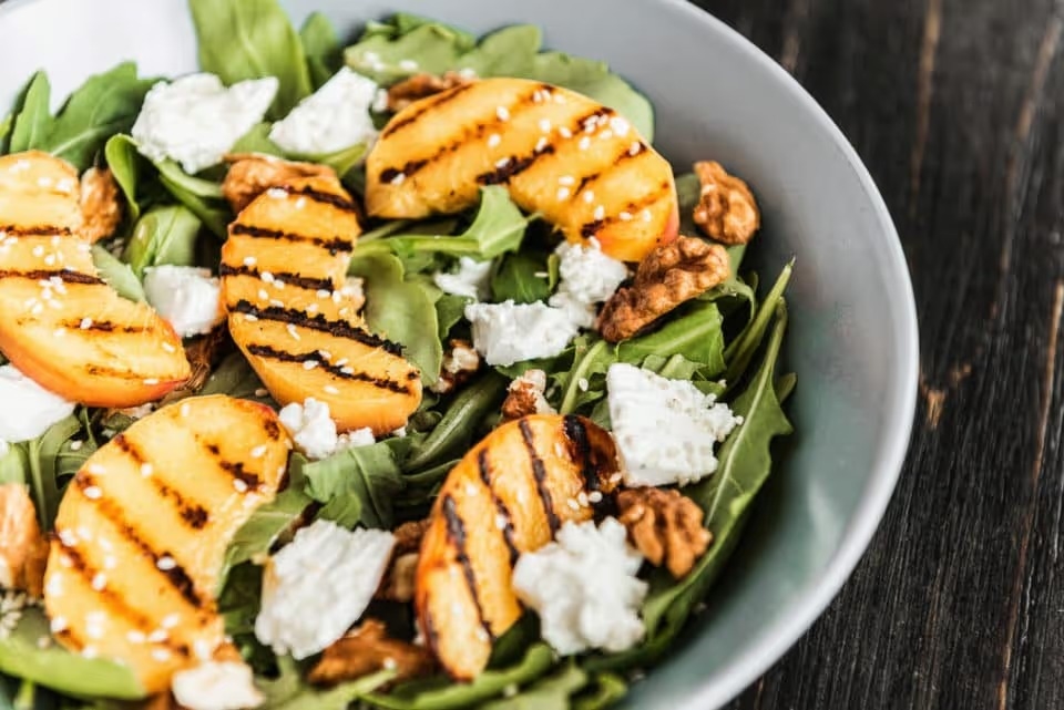 Salad of peaches grilled, cheese and arugula.