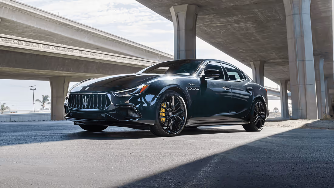 2025 Maserati Ghibli Modena parked underneath a modern bridge