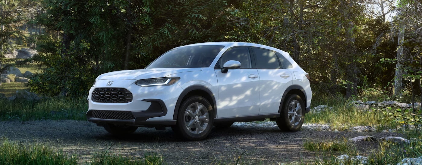 Black 2026 Honda HR-V driving down a dirt path.