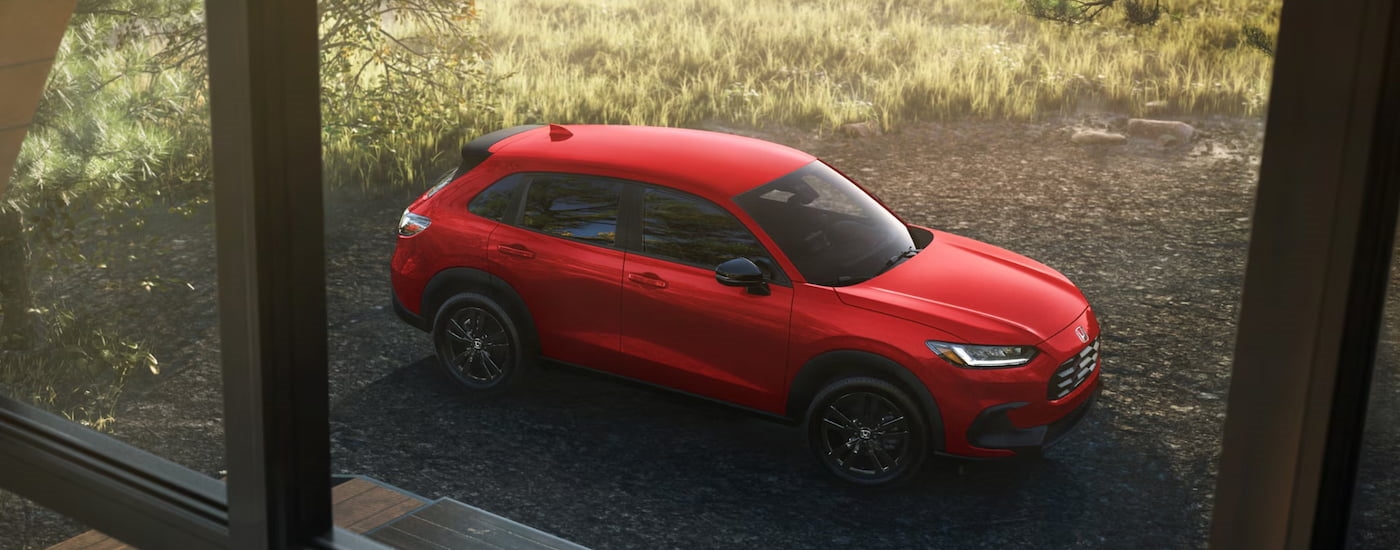 Red 2026 Honda HR-V parked outside a house.