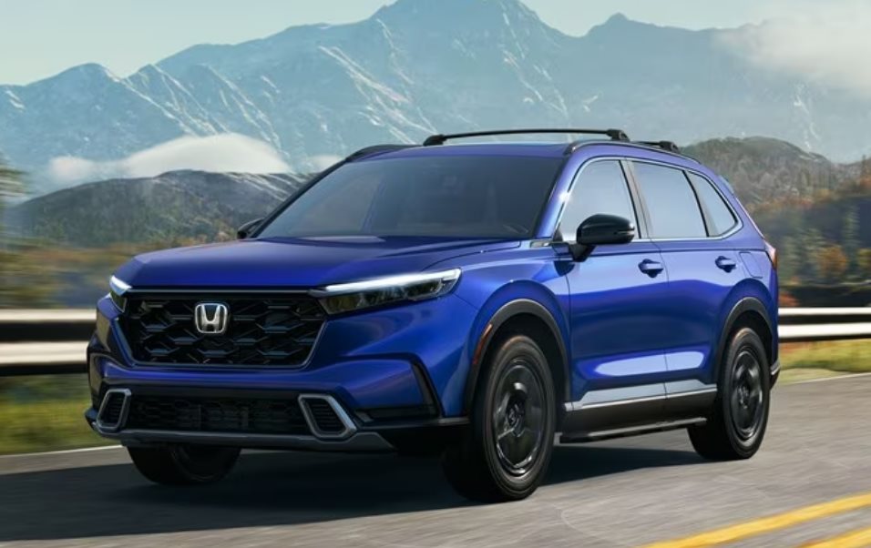 Honda CR-V Hybrid in blue driving on a mountain highway, with no charge port