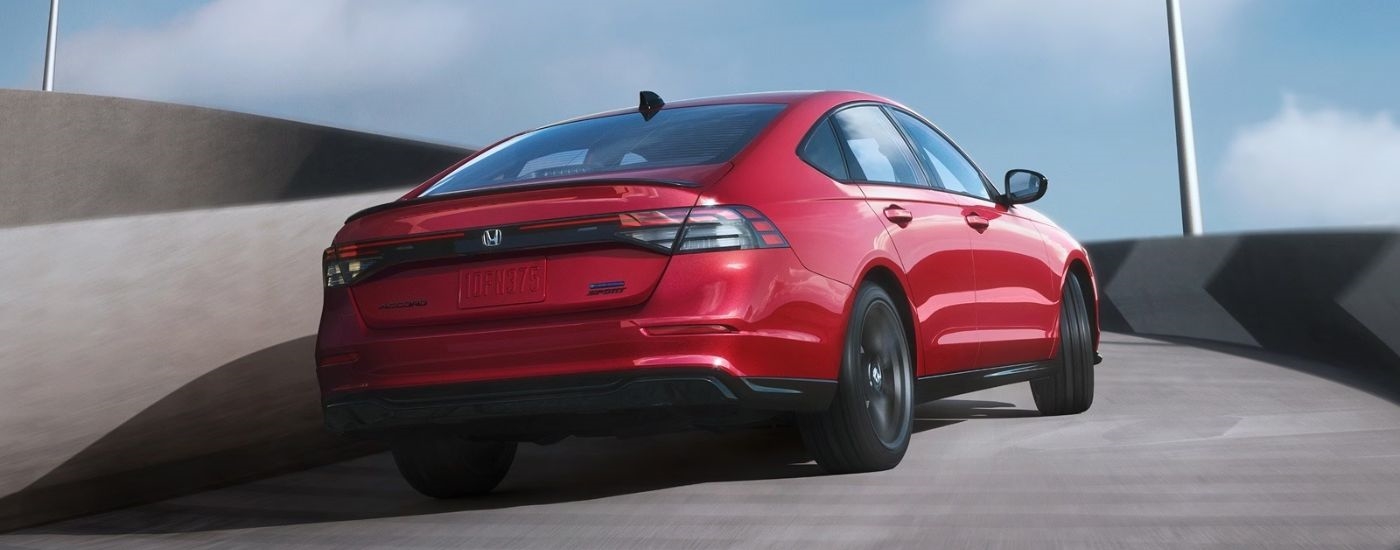 Rear view of a red 2026 Honda Accord Sport-L Hybrid.