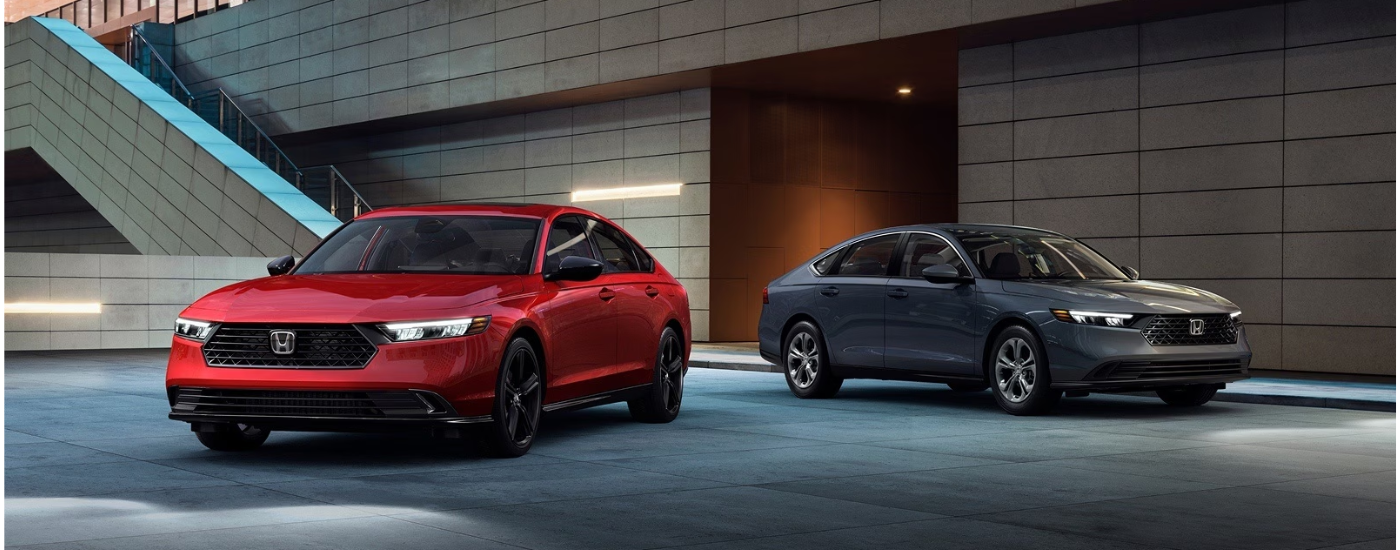 A red and a gray 2026 Honda Accord parked side-by-side.