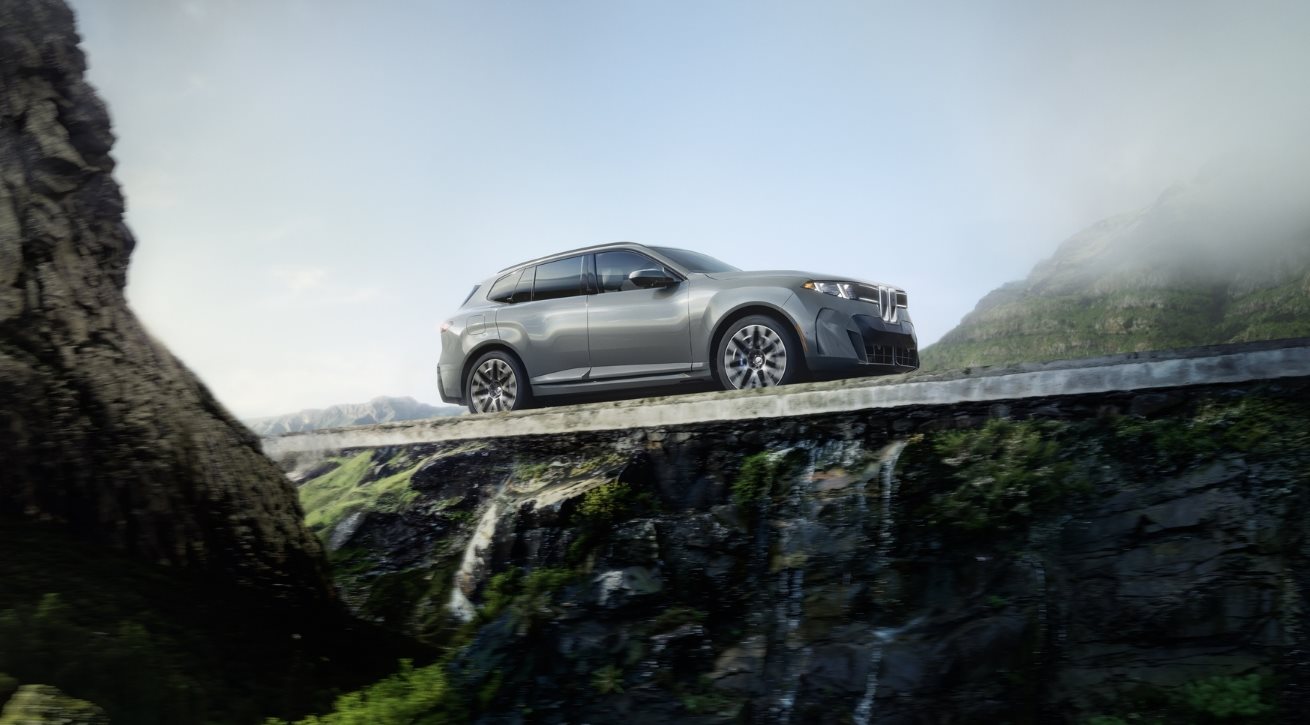 BMW luxury SUV driving along a scenic coastal road