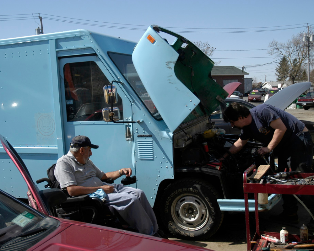 Rich Nimey with a mechanic working on a customer's vehicle