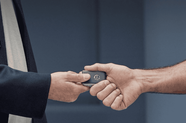 Person handing a key to another person