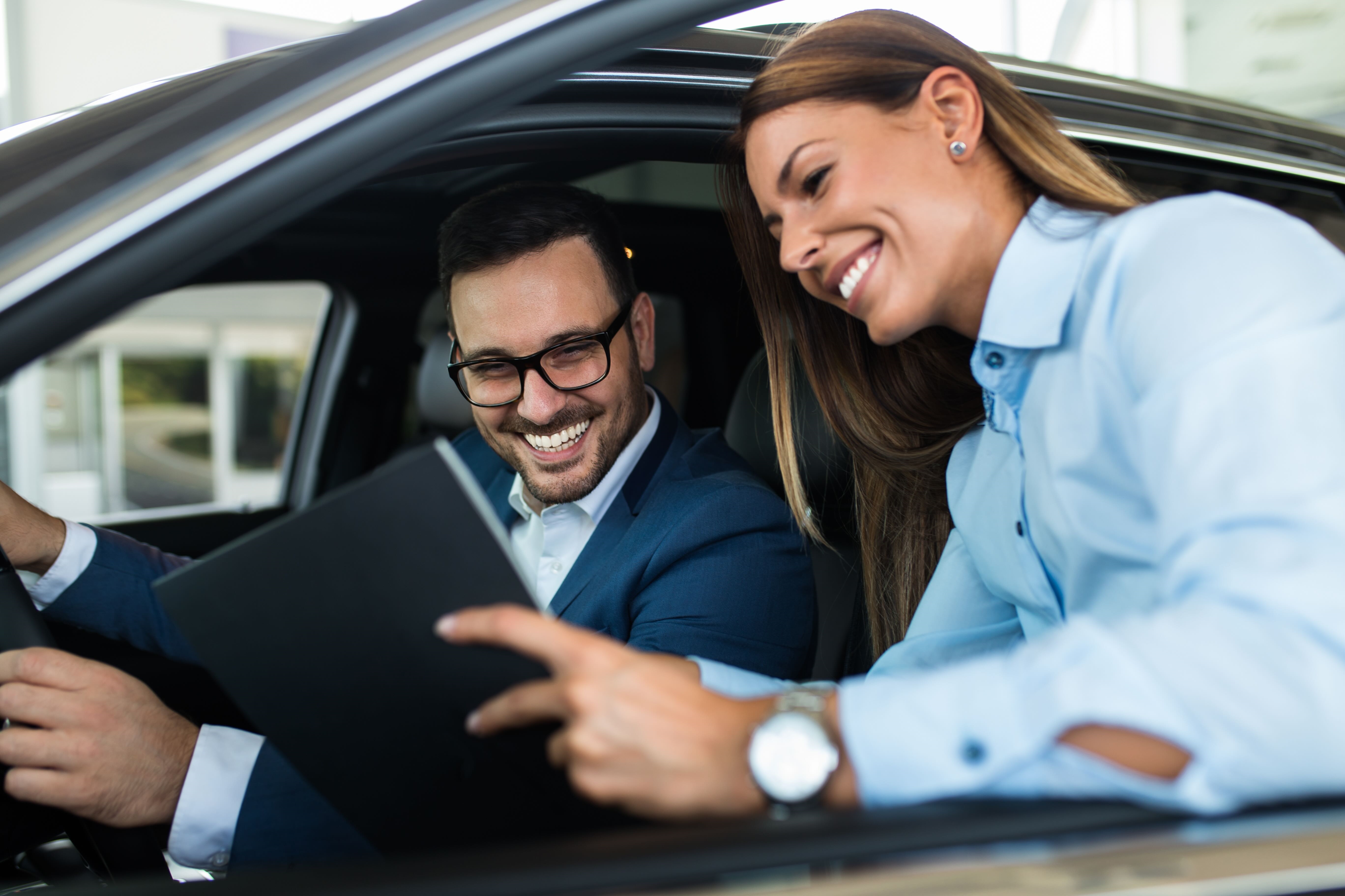 Dealership representative preparing customer for a test drive