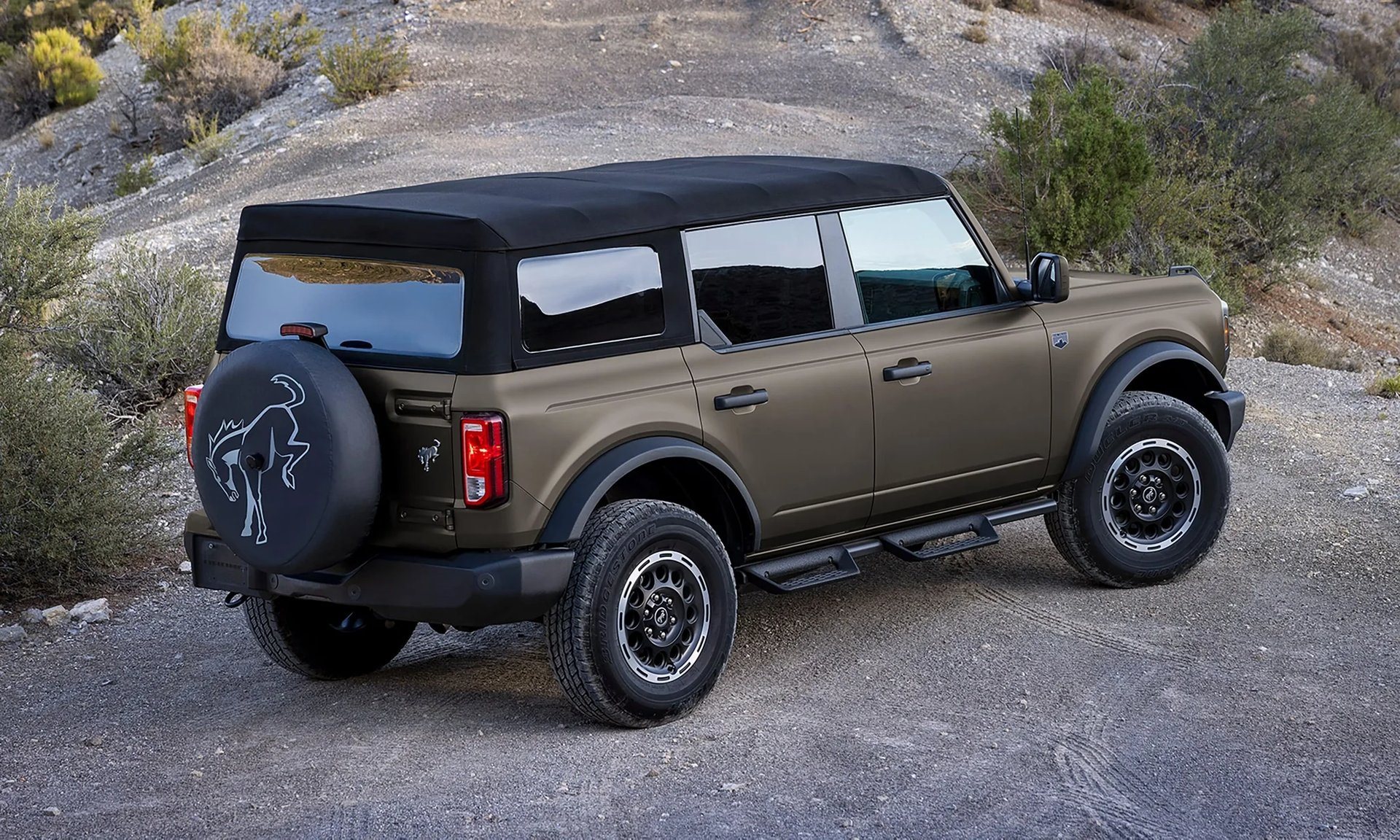 Side profile of a 2026 Ford Bronco 4-door with a soft top, showing its short two-row body