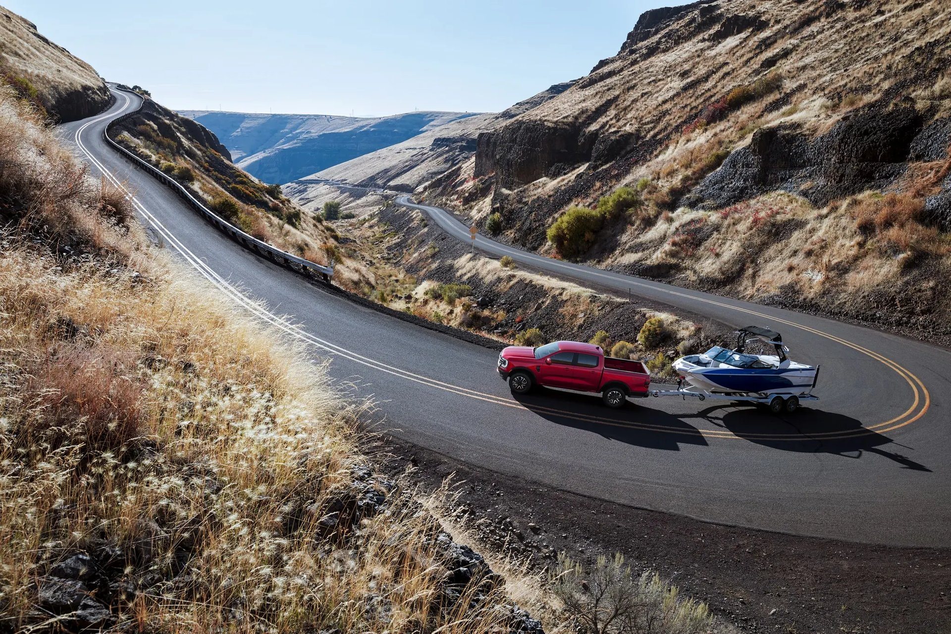 2026 Ford Ranger towing a boat on a winding mountain road