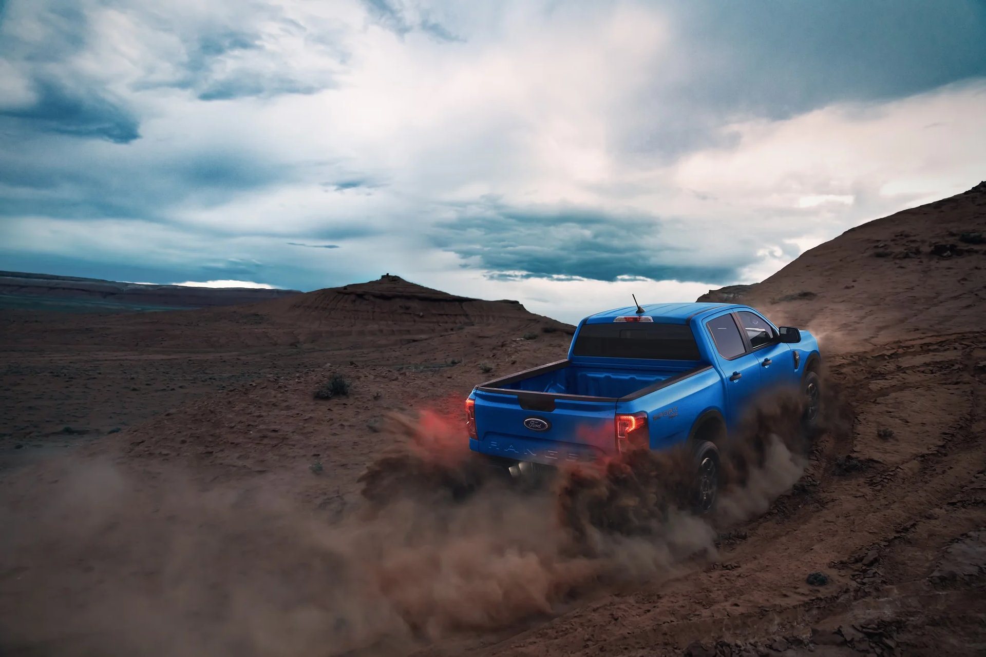 2026 Ford Ranger XLT driving up a steep dirt hill, midsize pickup at Jenkins and Wynne Ford in Clarksville, TN