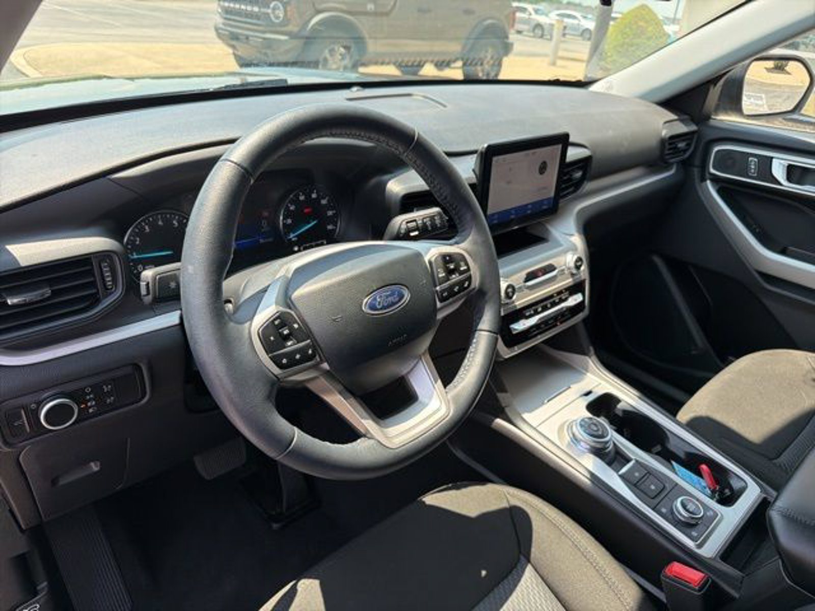Front seats and dashboard of a used 2024 Ford Explorer XLT