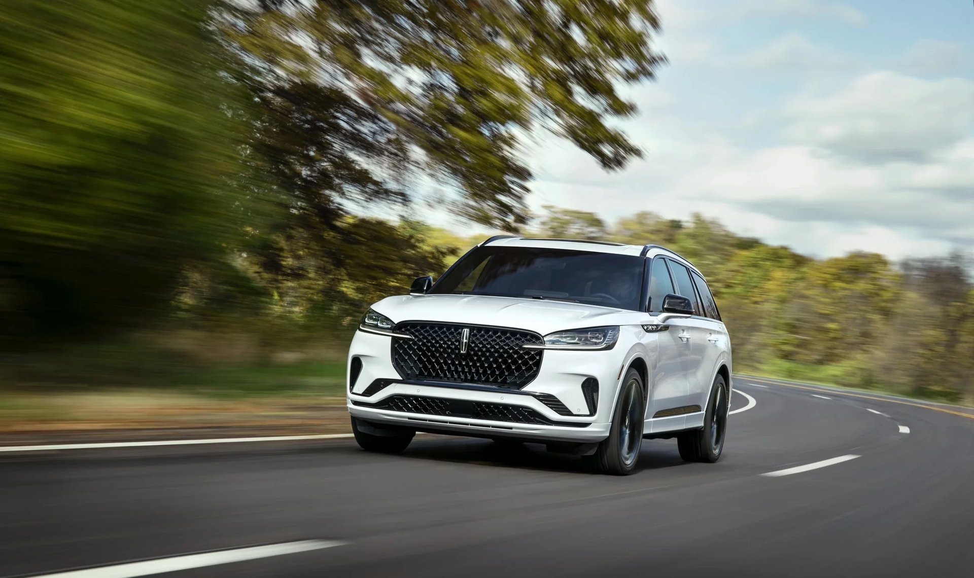 Lincoln Aviator driving on a tree-lined road