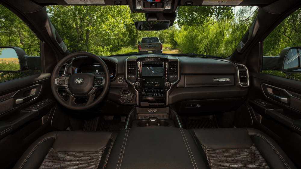 2026 Ram 1500 interior in Margate FL with RAM steering wheel, vertical touchscreen, and black seats