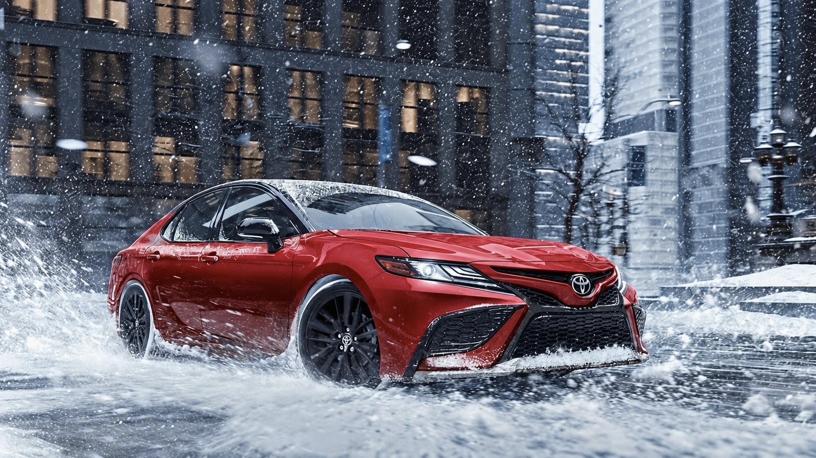 A Toyota hybrid parked on a snowy Chicago street on a cold winter morning.