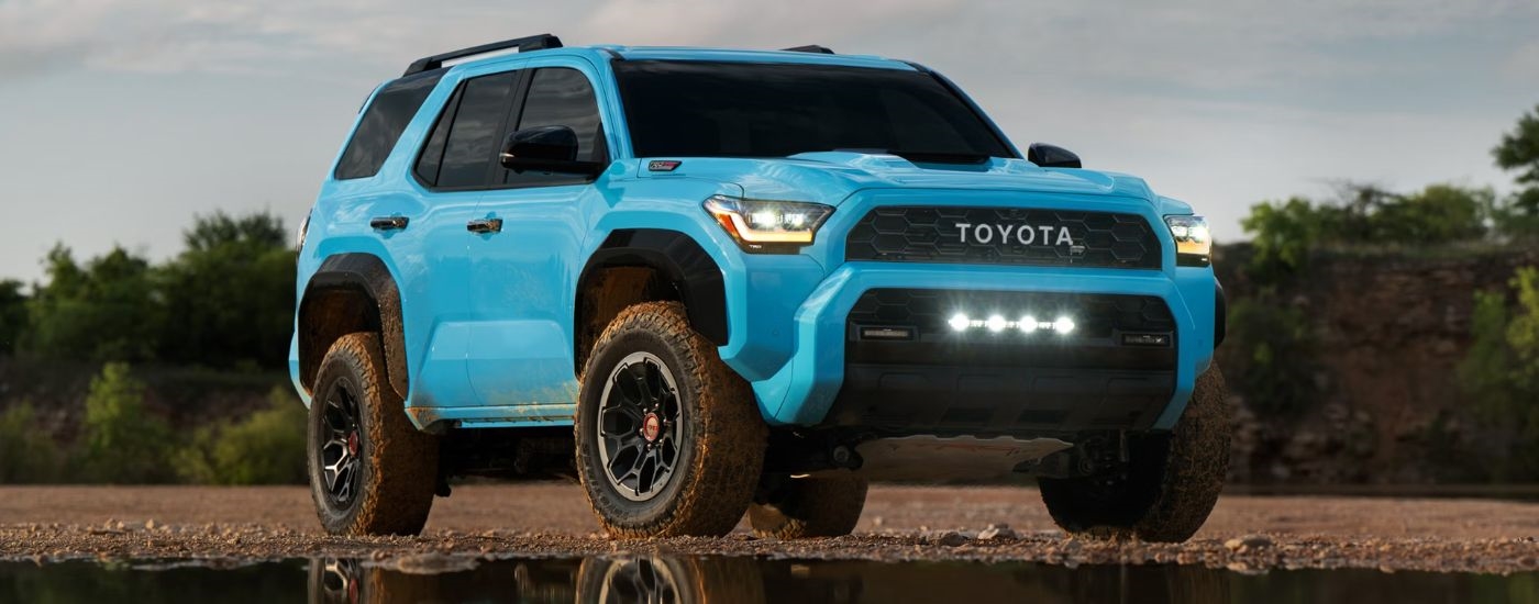 A light blue 2026 Toyota 4Runner TRD Pro parked by water.