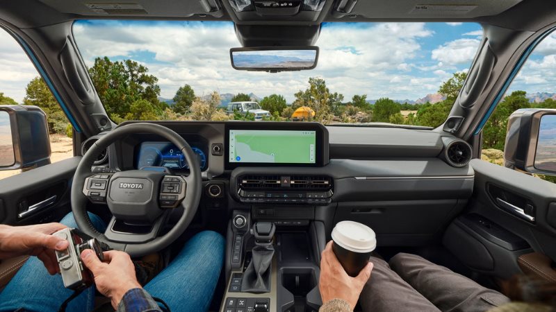 2027 Toyota Land Cruiser interior showing the second-row seats and touchscreen