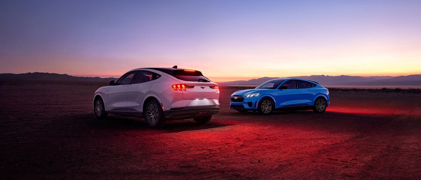 26Ford-MustangMachE-ExteriorPairParkedInDesertAtDusk