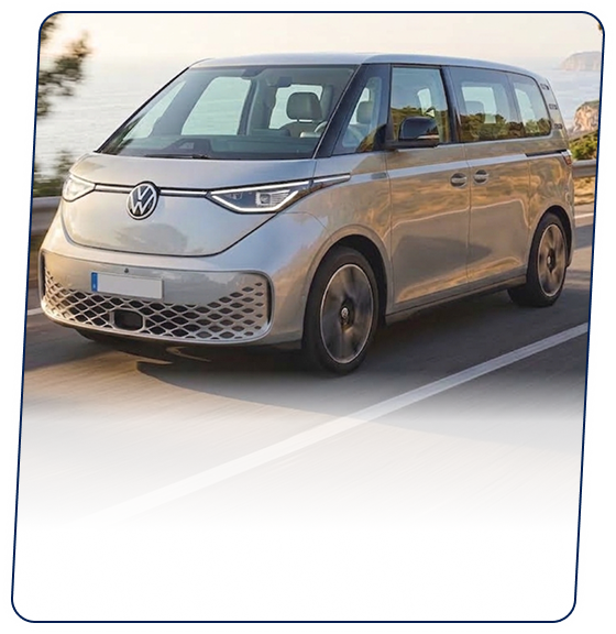 Silver Volkswagen van driving along a coastal highway
