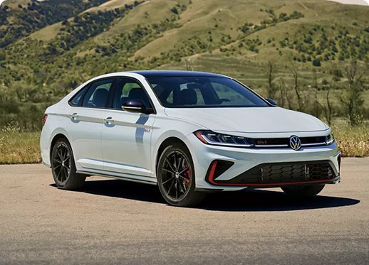 White Volkswagen Jetta GLI with red accents parked in the hills