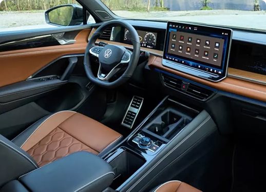 Volkswagen Tiguan cabin with cognac diamond-stitched leather seats and a large touchscreen