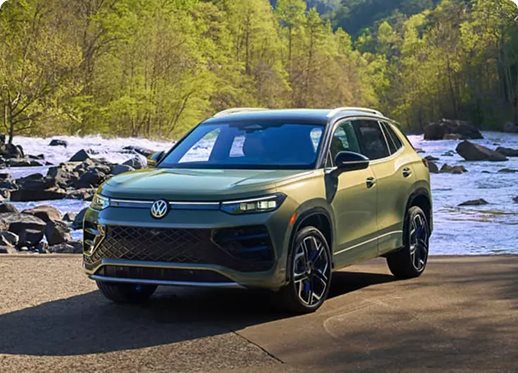 Green 2026 Volkswagen Tiguan SEL R-Line Turbo parked beside a rocky river