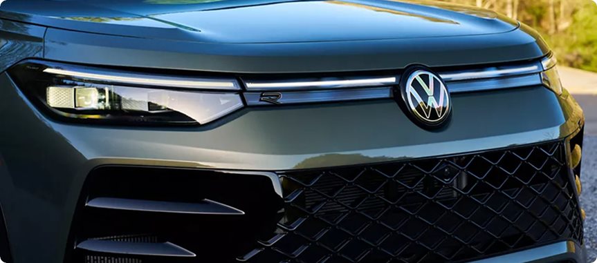Front of the Volkswagen Tiguan with a light bar across the grille and an illuminated VW emblem