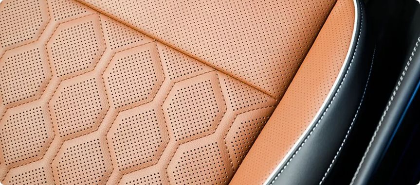 Close-up of cognac leather seating with diamond stitching and perforations