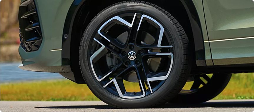 Two-tone 20-inch alloy wheel on a green Volkswagen Tiguan