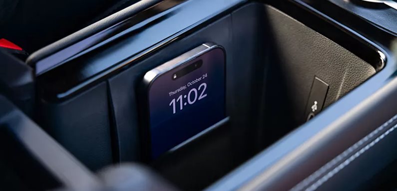 Smartphone resting on the wireless charging pad in the Volkswagen Tiguan console