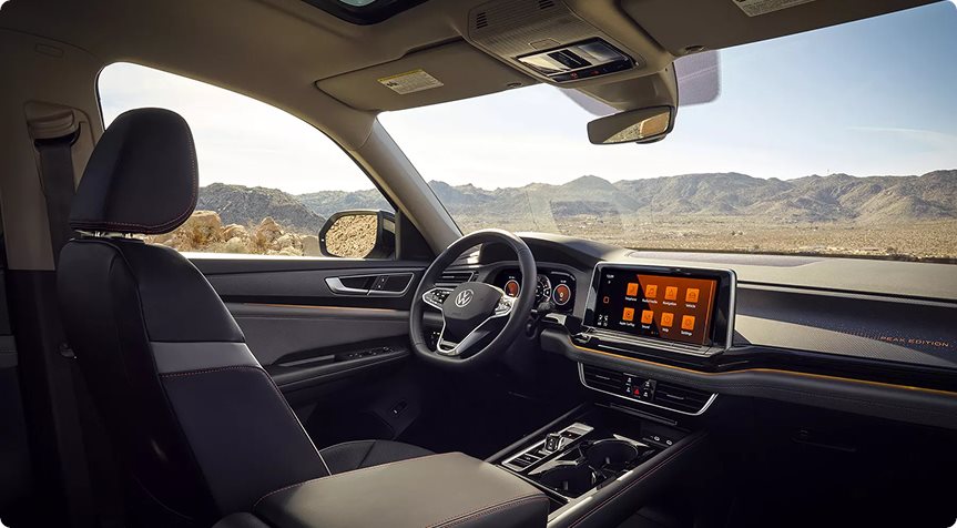 Dashboard and front seats of the Volkswagen Atlas Peak Edition with a desert view