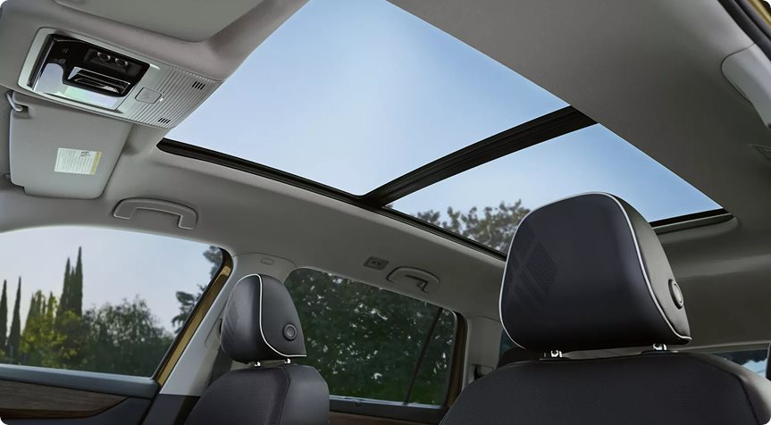 Open panoramic sunroof above the perforated front head restraints of the Volkswagen Atlas
