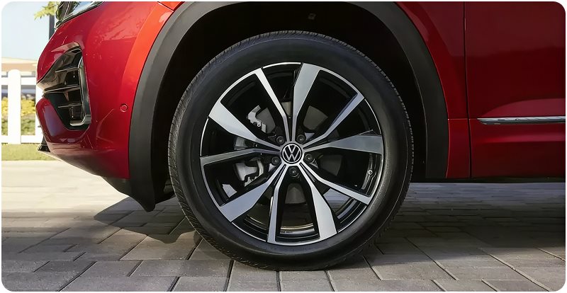 Two-tone alloy wheel on a red Volkswagen Atlas