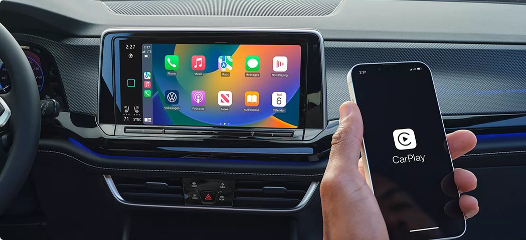 Apple CarPlay on the Volkswagen Atlas touchscreen next to a phone showing CarPlay