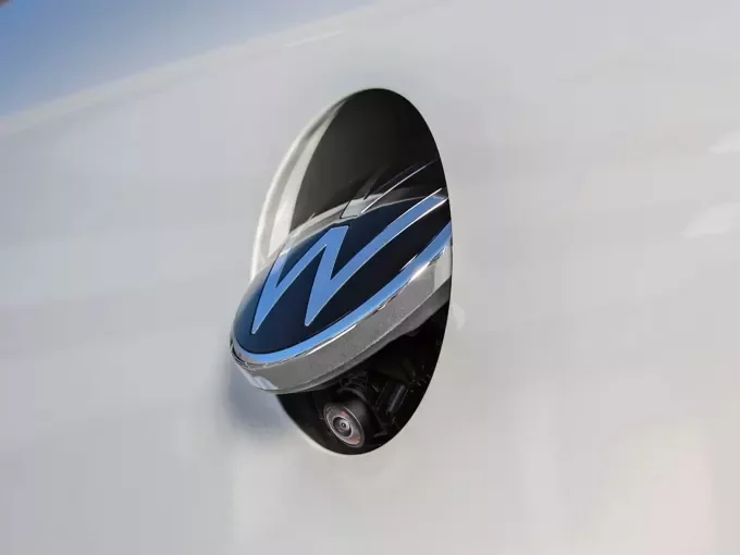 Close-up of the rear view camera housed in the Volkswagen emblem