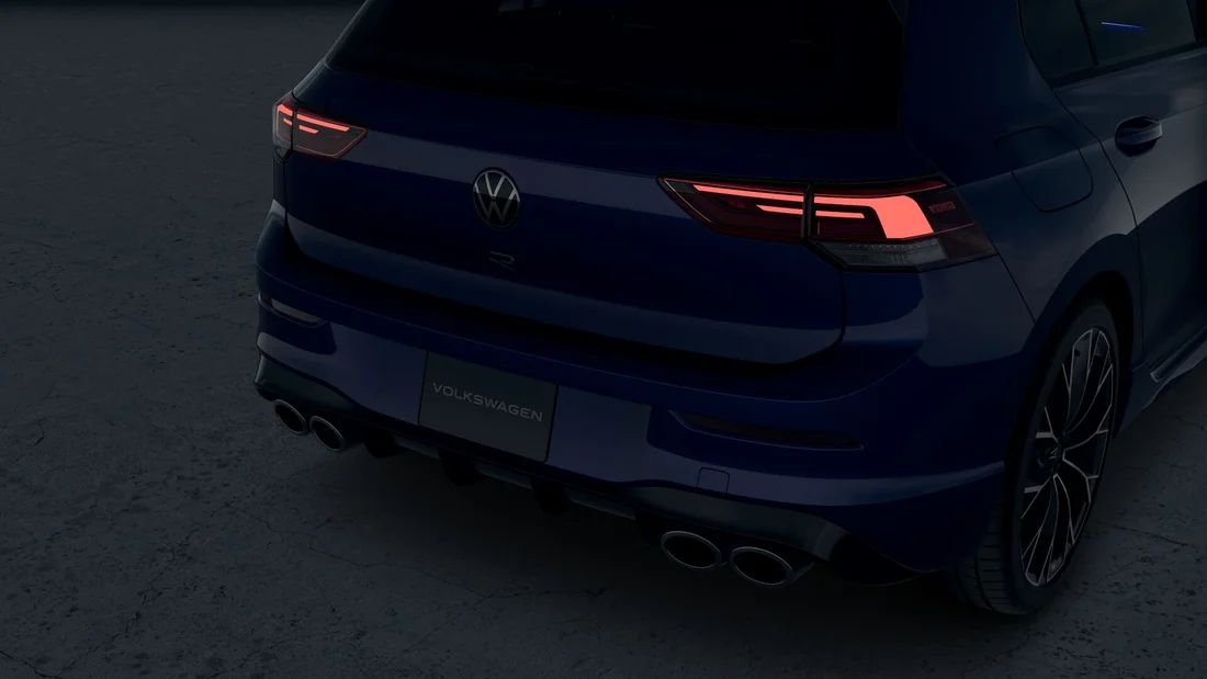 Rear of a dark Golf R in shadow with its LED taillights lit