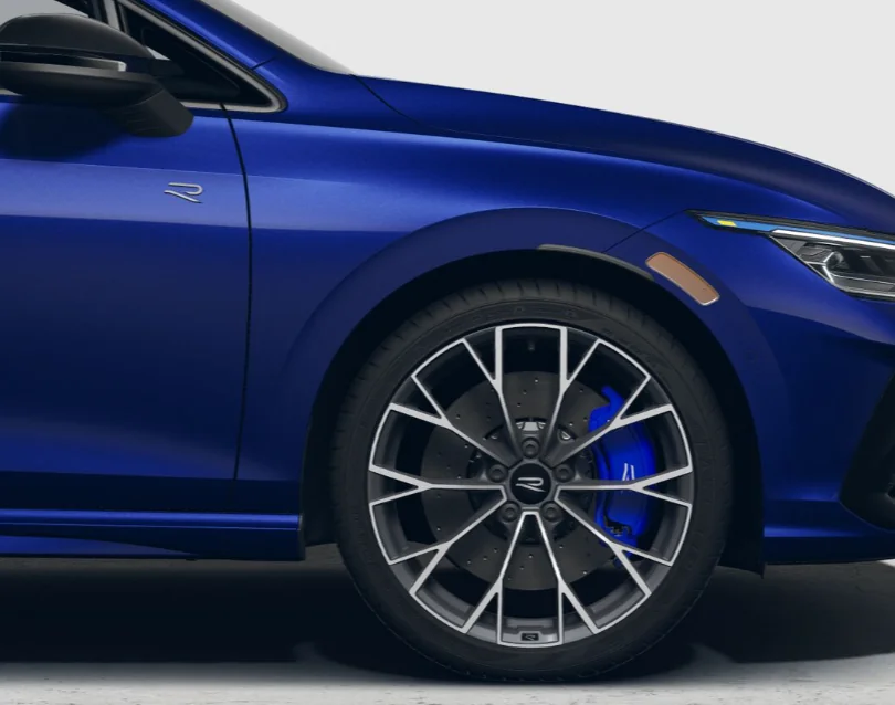 Close-up of a blue Golf R front wheel with blue brake calipers