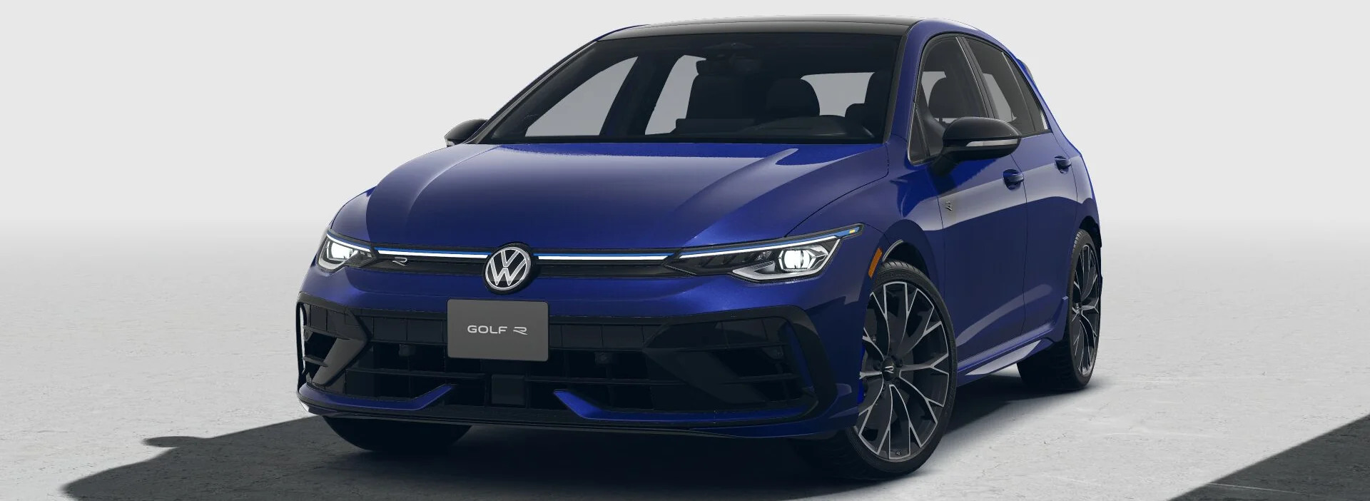 Front three-quarter view of a blue Golf R on a light gray backdrop