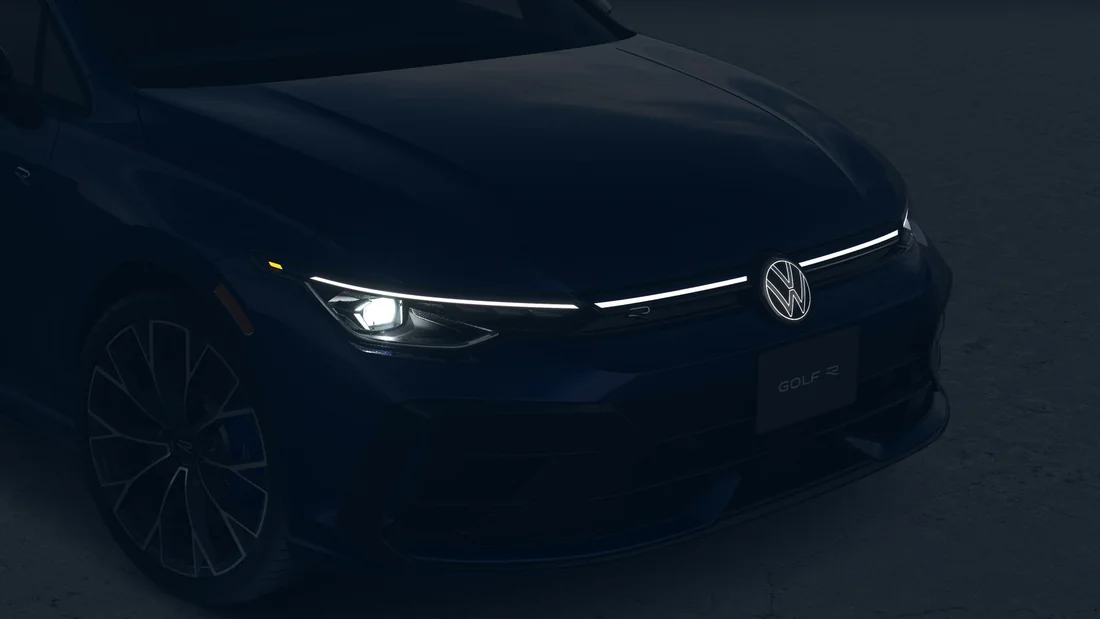 Front of a dark Golf R in shadow with its LED light bar glowing