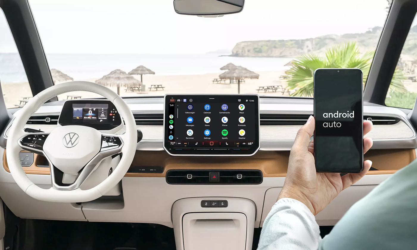 Passenger holding a phone showing Android Auto in the ID. Buzz