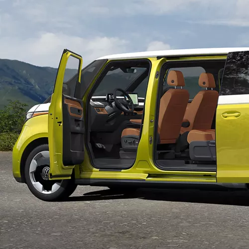 Yellow and white ID. Buzz with its sliding door open, showing cognac seats
