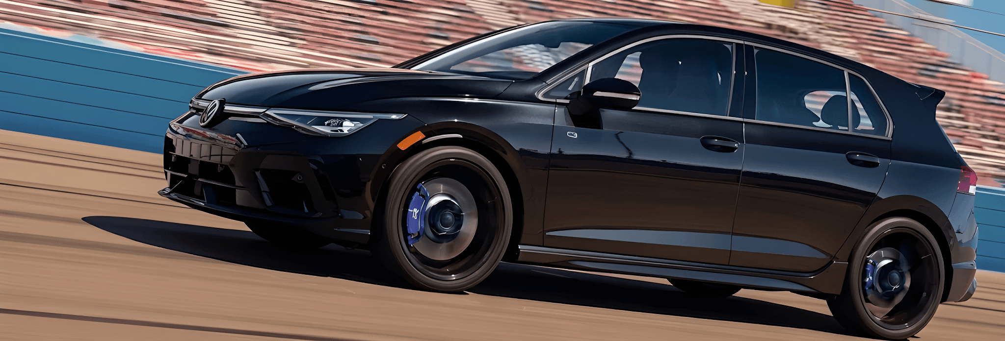Black 2026 Volkswagen Golf R speeding along a racetrack past the grandstands